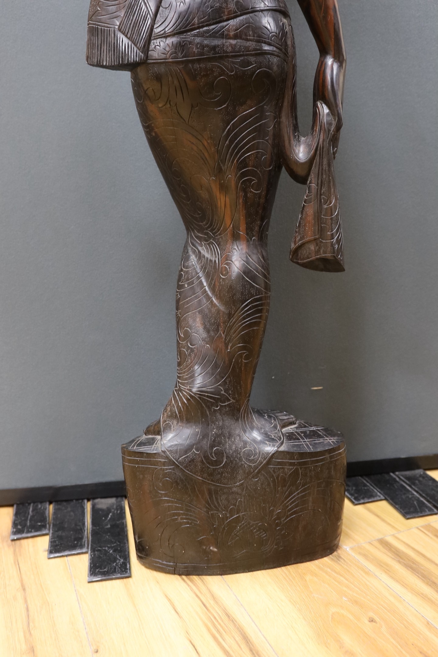 An unusually large and well-carved Balinese ebony figure of a standing young girl, early/mid 20th century. From a Bournemouth estate, 105cm high